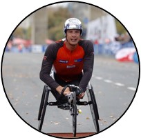 Marcel Hug in racing chair at finish line